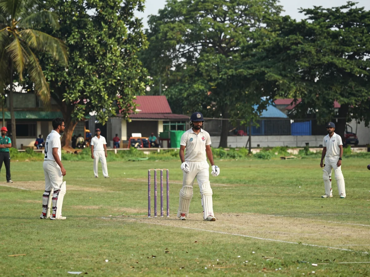 Bangladeshi domestic cricket match at a local ground, players in whites on a green outfield, natural daylight, humid aft